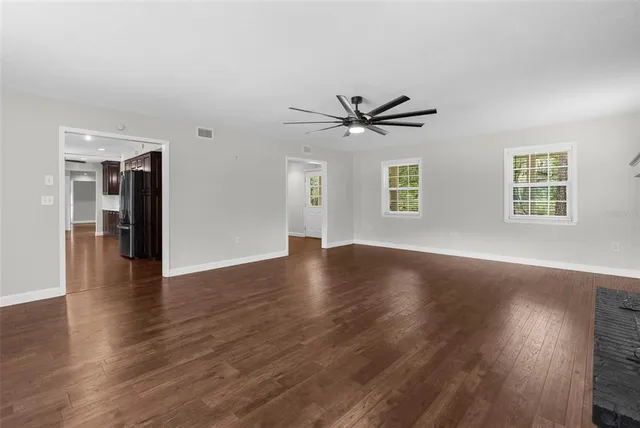 a open kitchen with stainless steel appliances granite countertop a sink a stove and a refrigerator