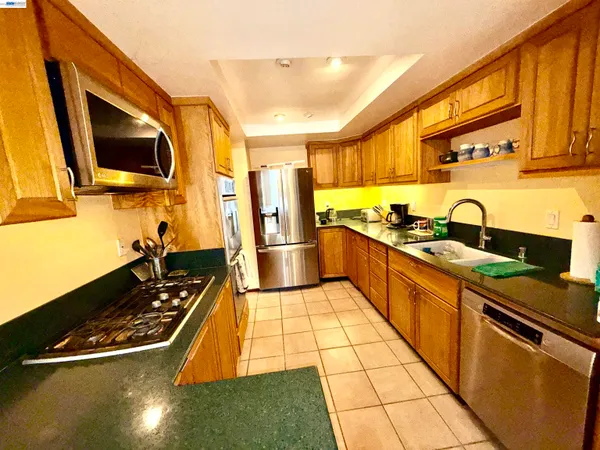 a kitchen with stainless steel appliances a stove a sink and a microwave