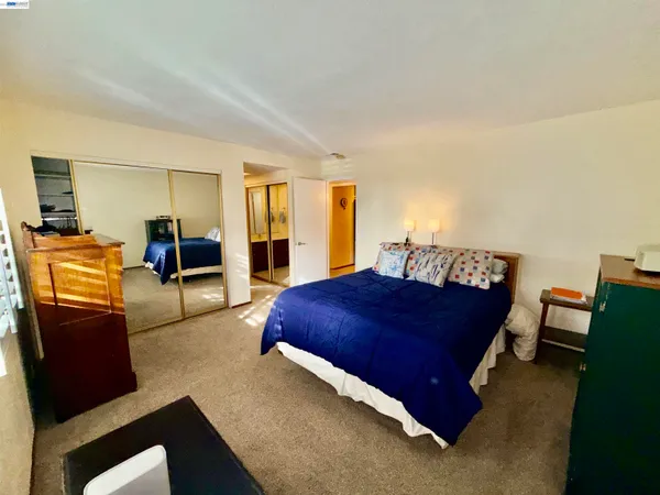 a bedroom with furniture and wooden floor