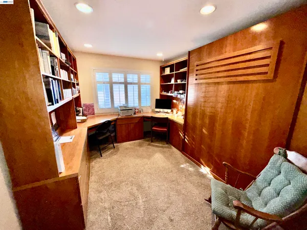 a living room with furniture and a book shelf