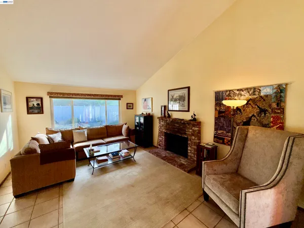 a living room with furniture and a dining table with garden view