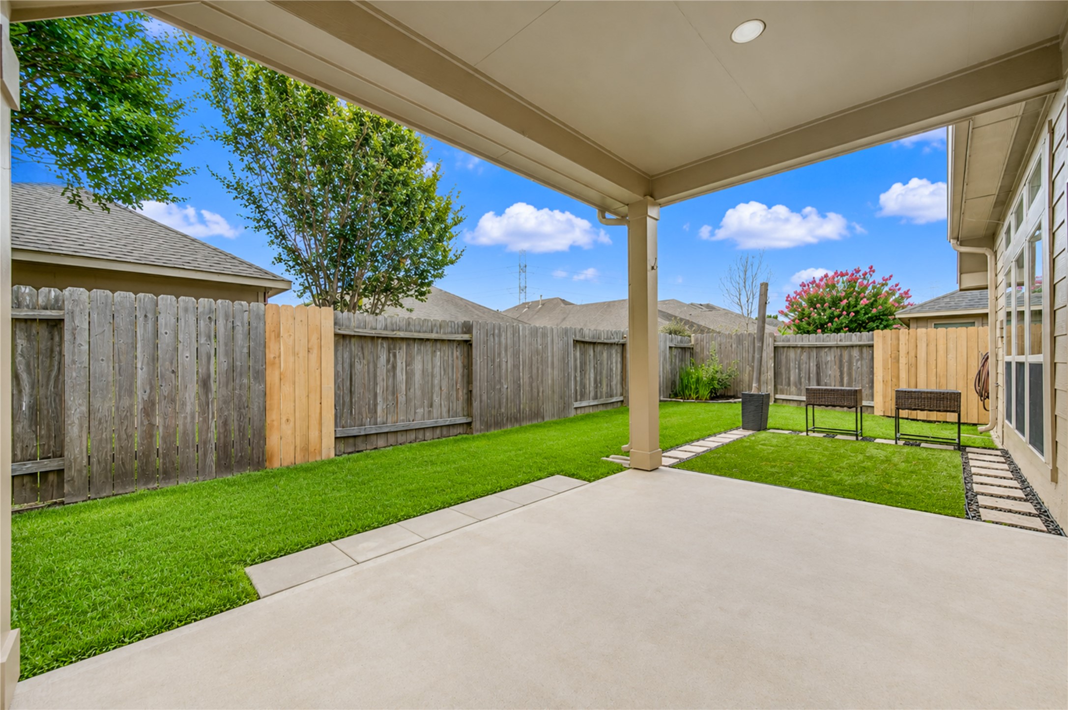 27407 Gatlin Lane Spring, TX 77386 - Photo 32 of 35 Enjoy seamless indoor and outdoor living with easy access from the home to the covered patio and backyard, making entertaining and everyday gatherings effortless.
