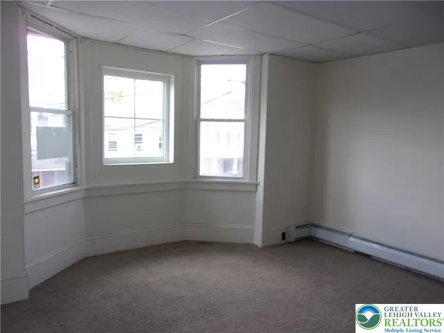 a view of an empty room and a window