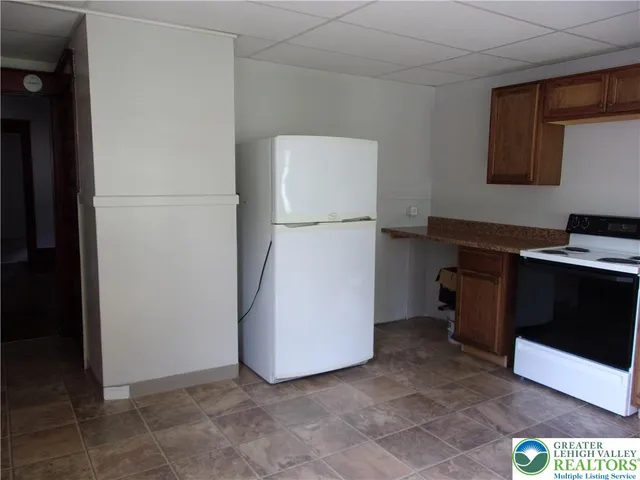a kitchen with stainless steel appliances a sink stove and cabinets