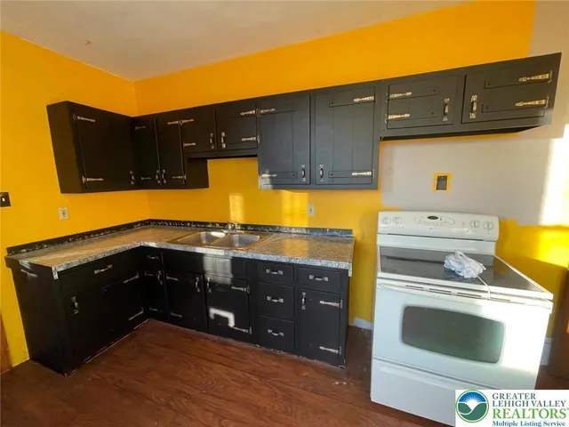 a kitchen with a sink and cabinets