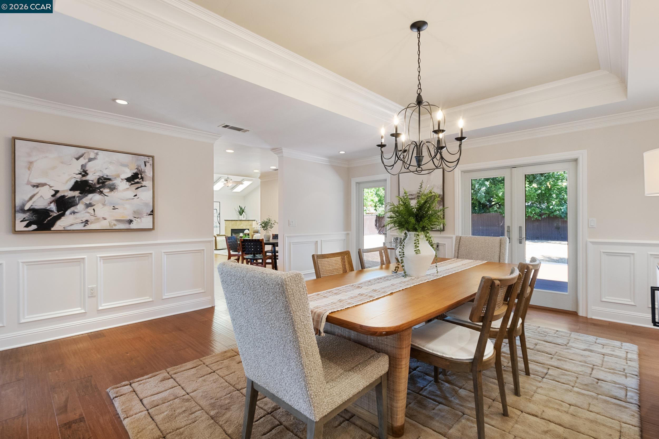484 Diablo Road Danville, CA 94526 - Photo 11 of 39 a dining room with wooden floor a chandelier a wooden table and chairs