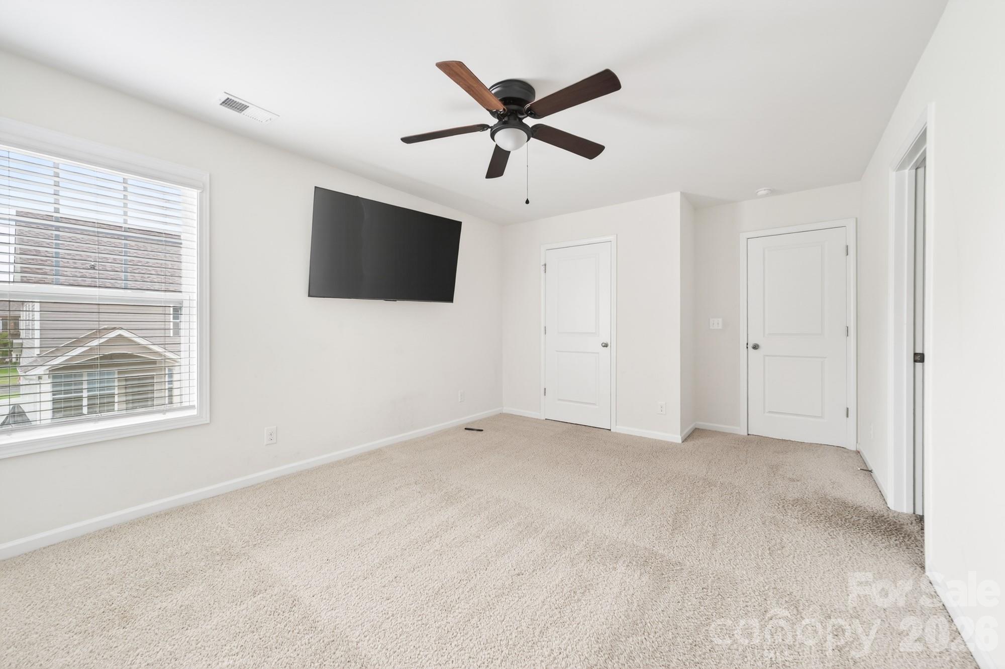 5972 Redwood Pine Road Concord, NC 28027 - Photo 28 of 37 an empty room with ceiling fan and windows
