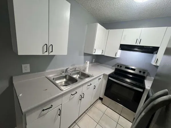 a kitchen with cabinets and appliances