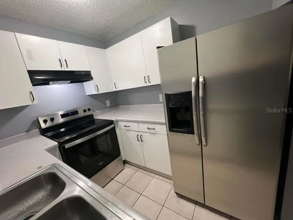 a kitchen with stainless steel appliances a refrigerator and a stove