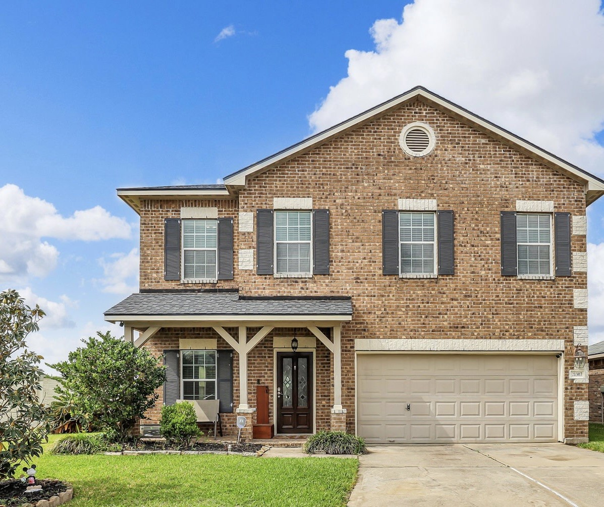 21307 Carleen Creek Trail Spring, TX 77379 - Photo 1 of 25 Two-story brick home with a charming front porch and a two-car garage.