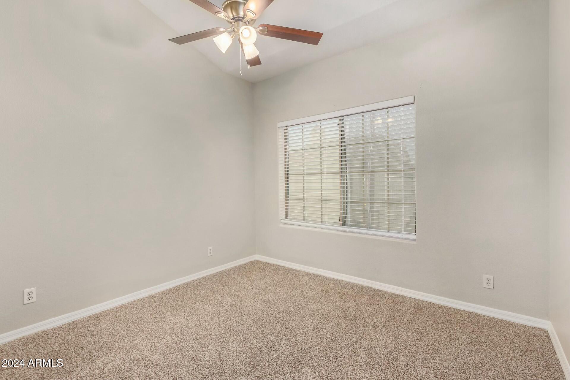 2801 North Litchfield Road, Unit 18 Goodyear, AZ 85395 - Photo 15 of 21 an empty room with windows and fan