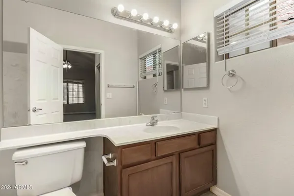 a bathroom with a sink a vanity and a mirror