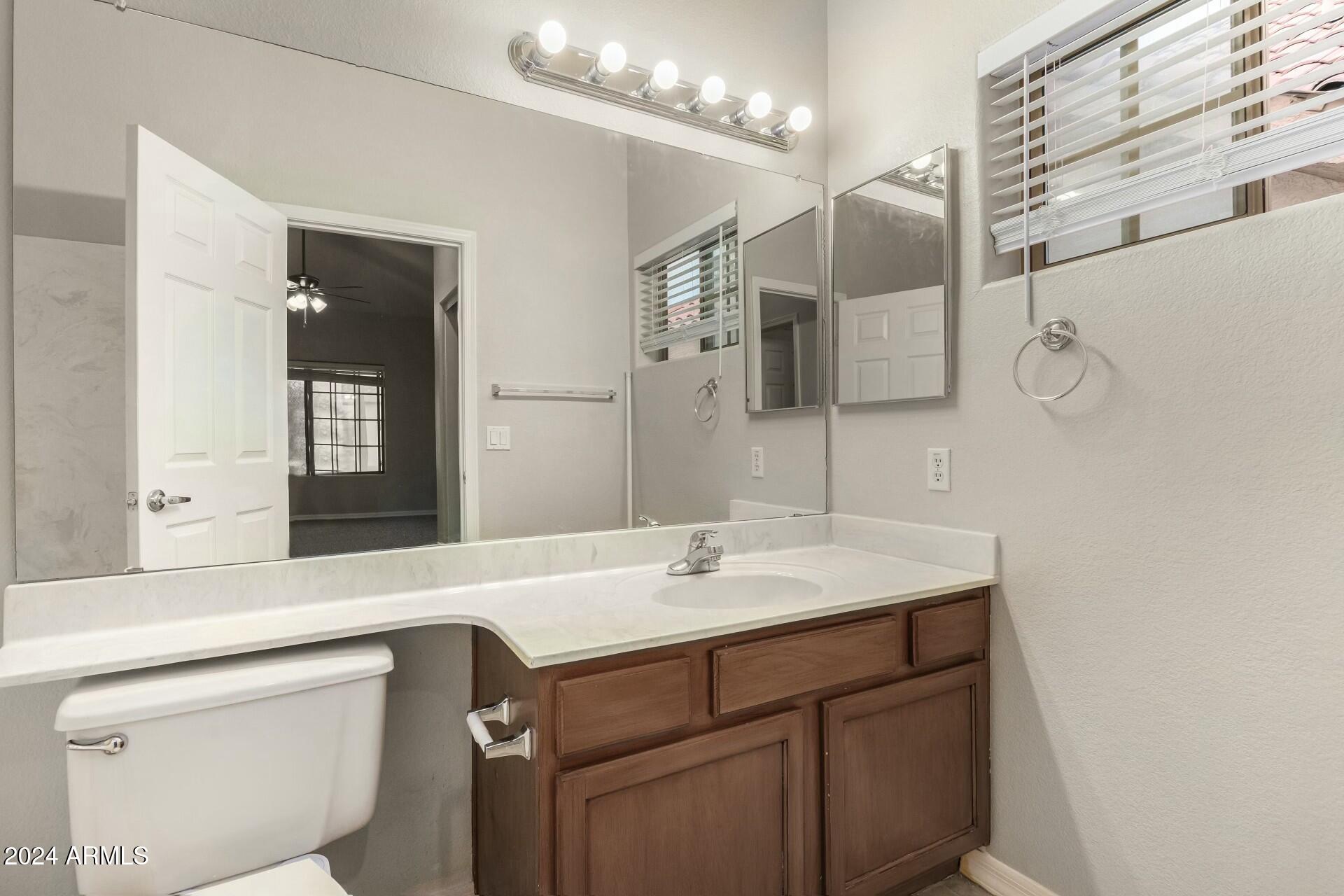 2801 North Litchfield Road, Unit 18 Goodyear, AZ 85395 - Photo 10 of 21 a bathroom with a sink a vanity and a mirror