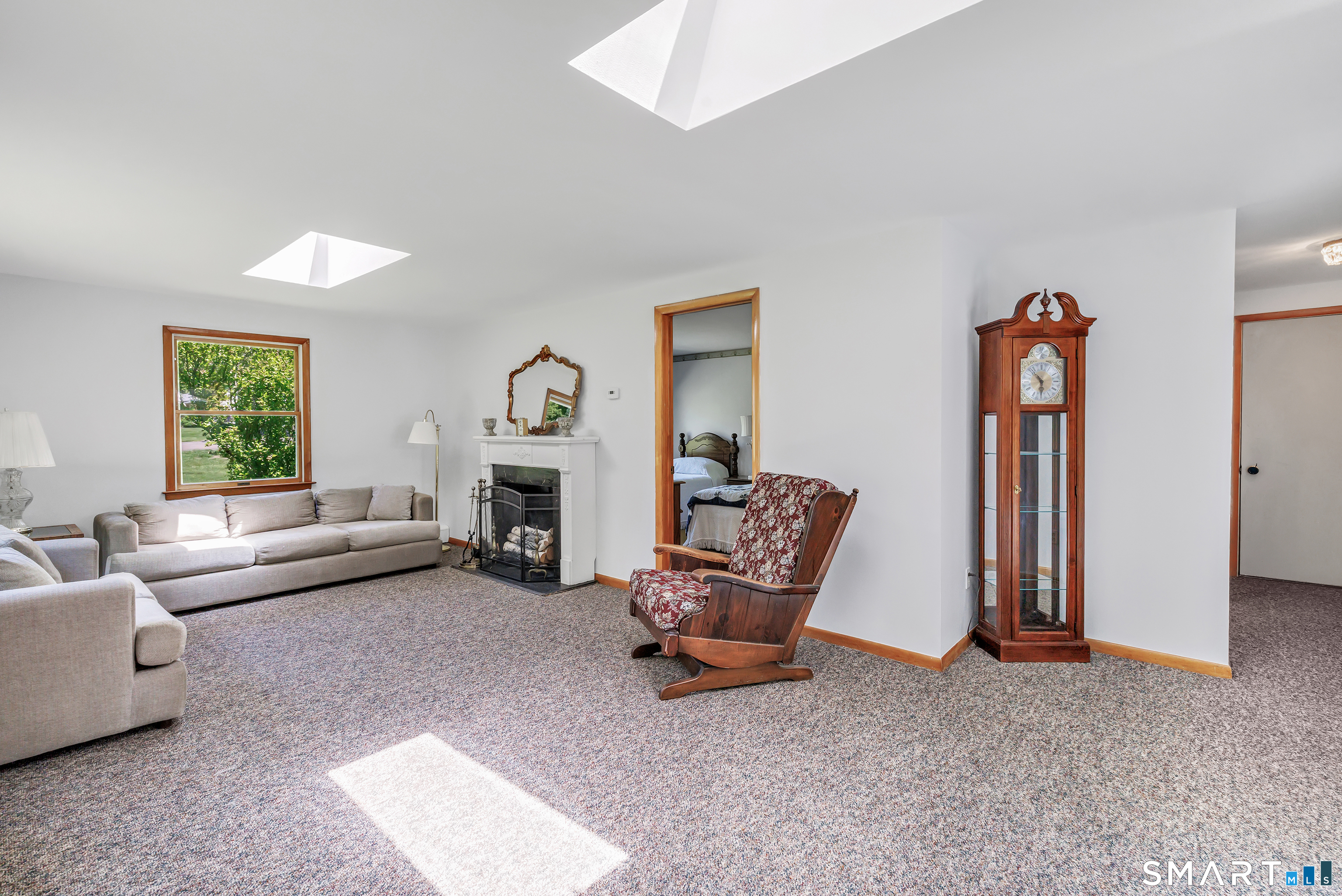 223 Wheeler Road Monroe, CT 06468 - Photo 14 of 35 a living room with furniture and a fireplace
