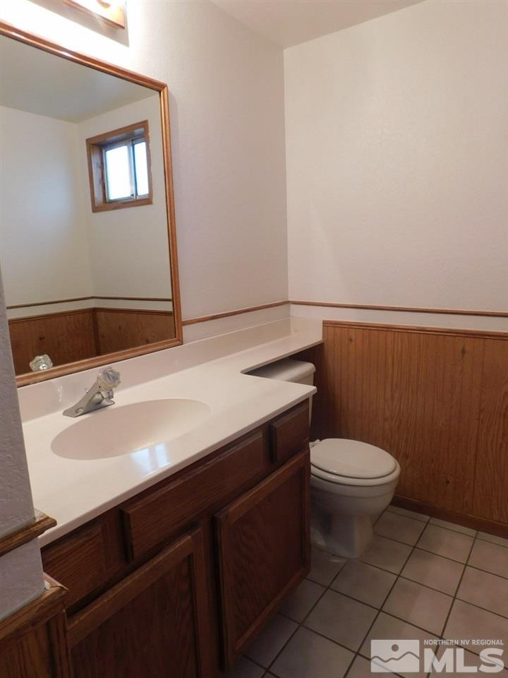 800 Isis Court Reno, NV 89512 - Photo 6 of 15 a bathroom with a sink a toilet and a mirror