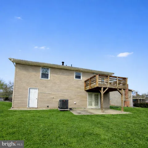 a front view of a house with a garden and a table