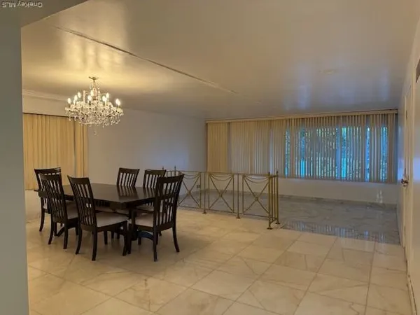 a view of a dining room with furniture and chandelier