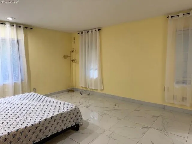 a bedroom with a bed and a shower