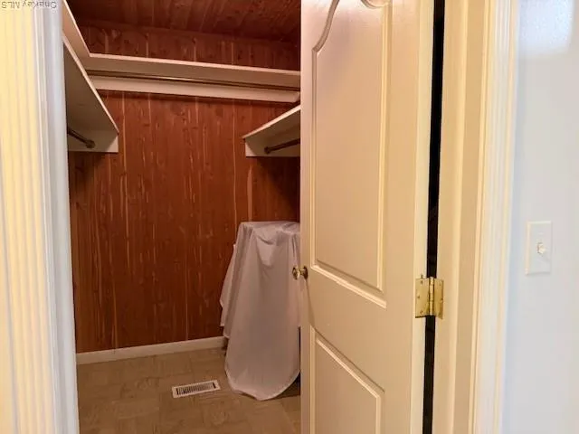 a view of walk in closet with clothes