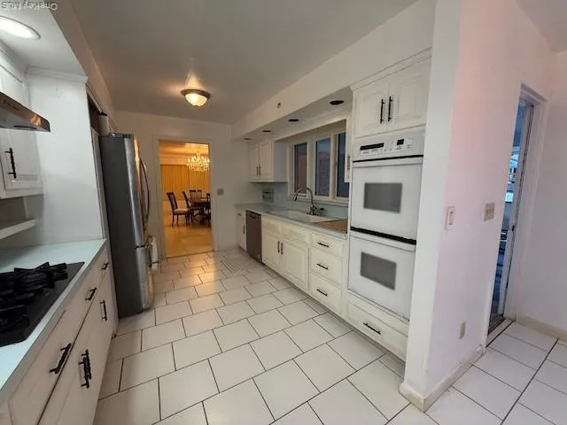 a kitchen with stainless steel appliances a stove refrigerator sink and cabinets