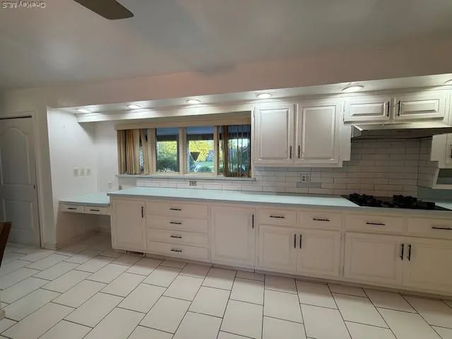 a spacious bathroom with a granite countertop sink and a mirror