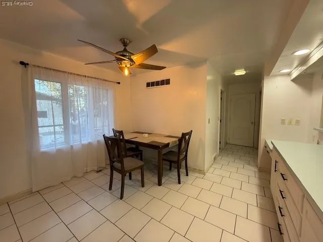 a view of a dining room with furniture and window