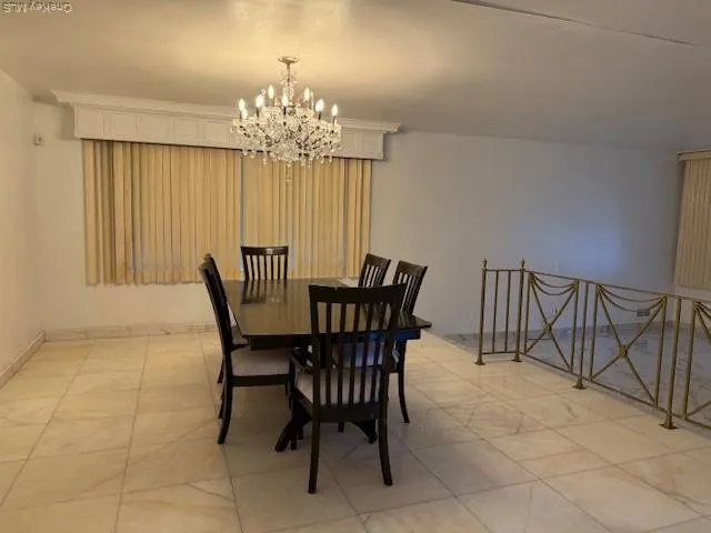 a view of a dining room with furniture and chandelier