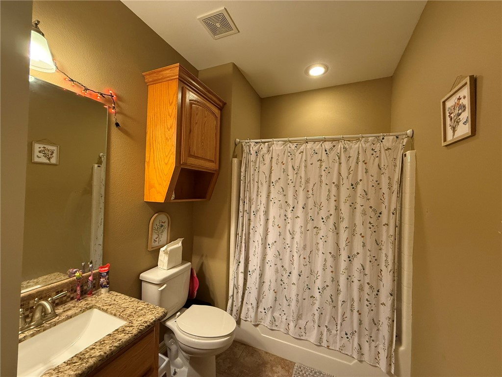 137 Lk Vw Terrace Three Rivers, TX 78071 - Photo 12 of 20 a bathroom with a granite countertop toilet sink and mirror