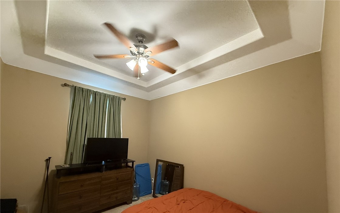 137 Lk Vw Terrace Three Rivers, TX 78071 - Photo 13 of 20 a bedroom with a bed and a chandelier