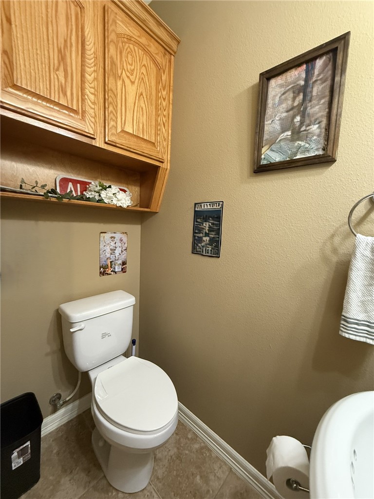 137 Lk Vw Terrace Three Rivers, TX 78071 - Photo 14 of 20 a white toilet sitting next to a bathroom and a window