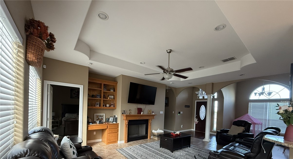 137 Lk Vw Terrace Three Rivers, TX 78071 - Photo 3 of 20 a living room with furniture a flat screen tv and a fireplace