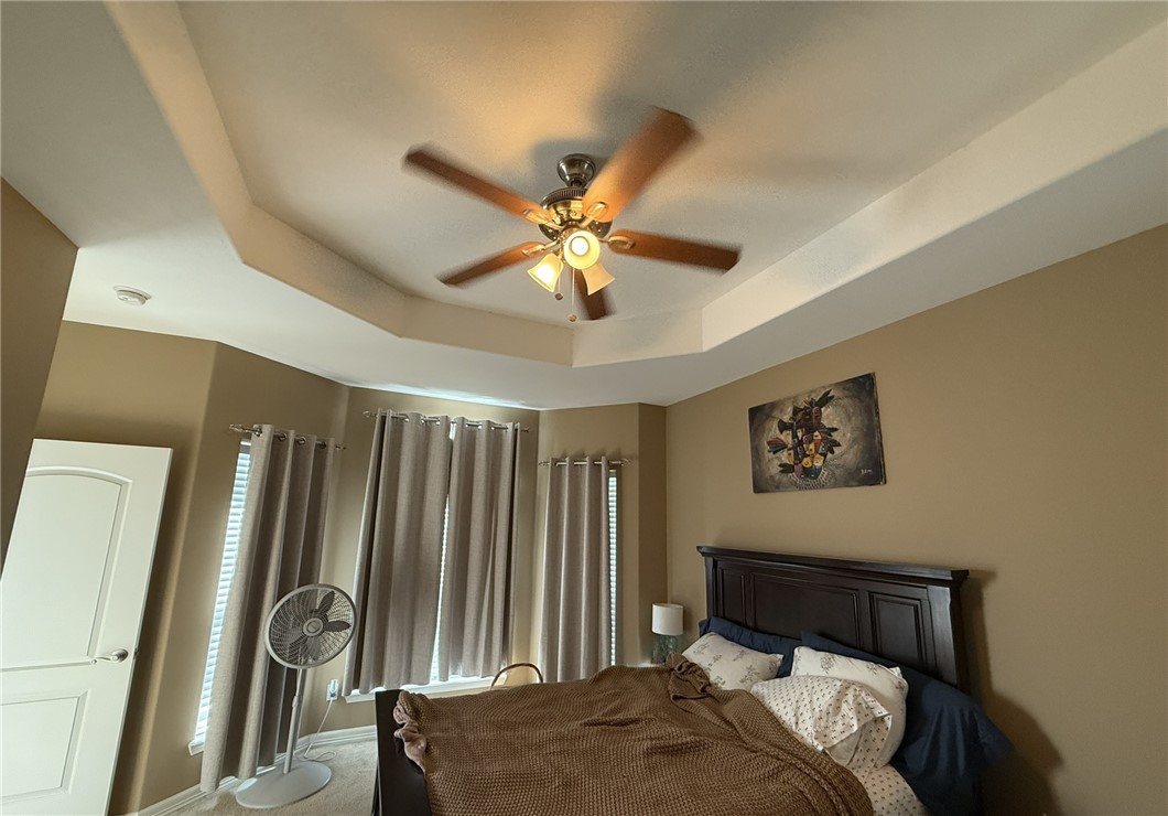 137 Lk Vw Terrace Three Rivers, TX 78071 - Photo 8 of 20 a bedroom with a bed and a chandelier