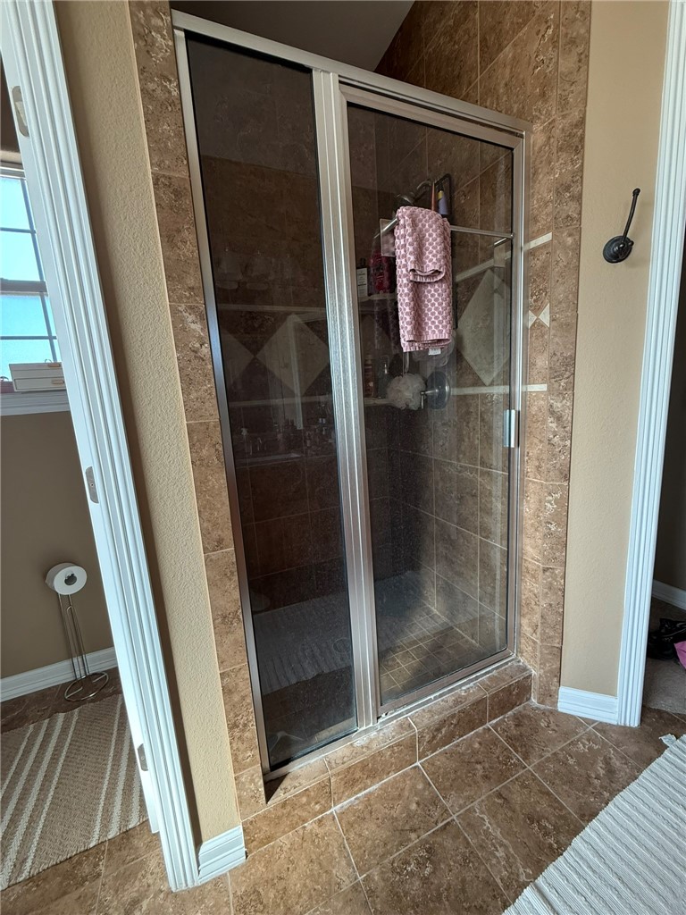137 Lk Vw Terrace Three Rivers, TX 78071 - Photo 9 of 20 a bathroom with a glass shower door