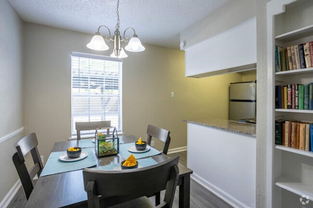 6505 Westheimer Road, Unit 328 Houston, TX 77057 - Photo 10 of 16 a view of a dining room with furniture window and wooden floor