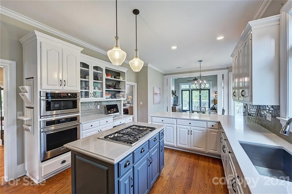 18731 River Falls Drive Davidson, NC 28036 - Photo 15 of 45 a kitchen with stainless steel appliances granite countertop a stove and a wooden floors