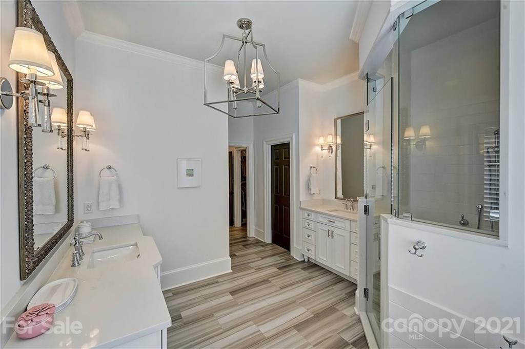 18731 River Falls Drive Davidson, NC 28036 - Photo 23 of 45 a bathroom with a sink a mirror and a shower