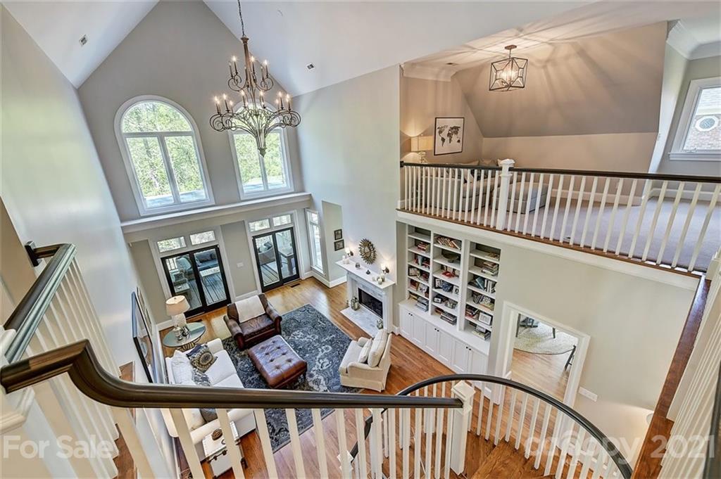 18731 River Falls Drive Davidson, NC 28036 - Photo 24 of 45 a view of a porch with furniture wooden floor and windows
