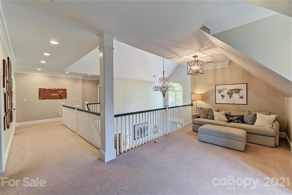 18731 River Falls Drive Davidson, NC 28036 - Photo 26 of 45 a living room with furniture and a chandelier