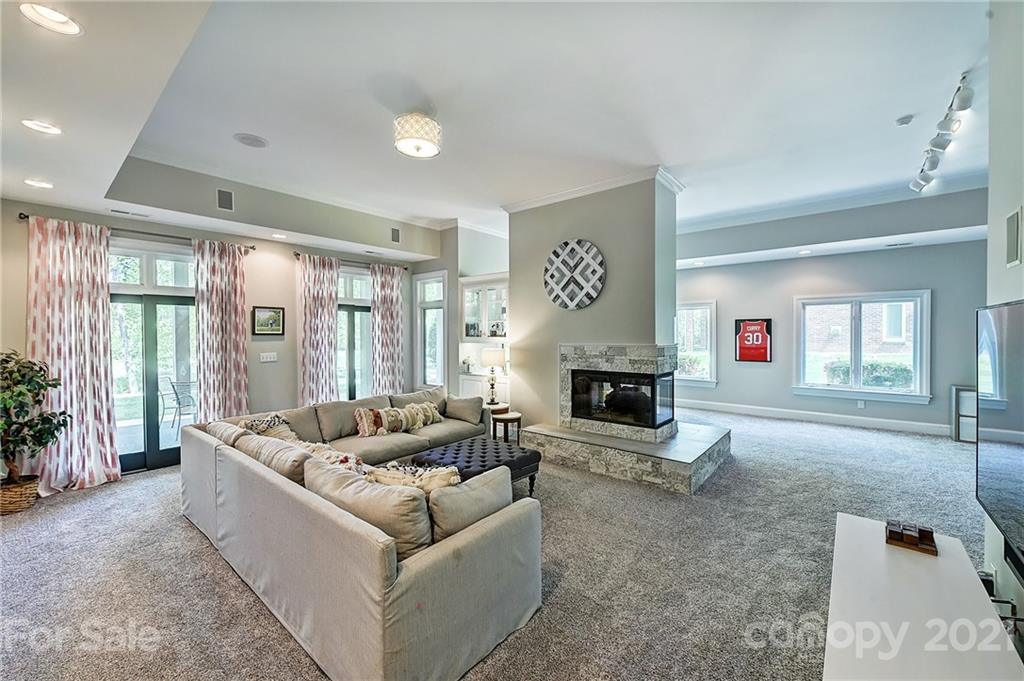 18731 River Falls Drive Davidson, NC 28036 - Photo 4 of 45 a living room with furniture and a fireplace