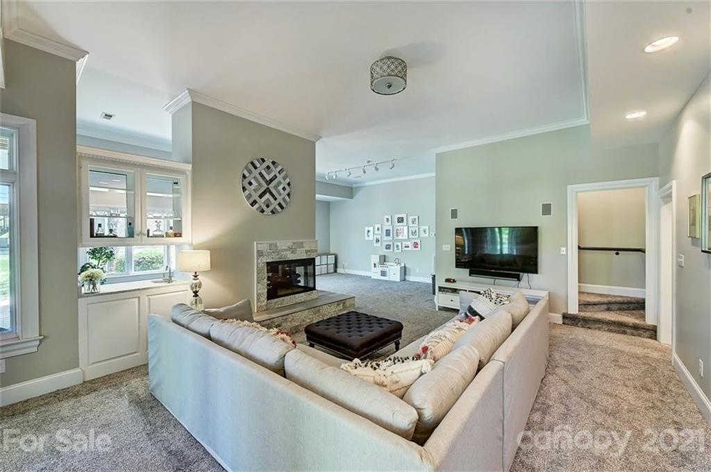 18731 River Falls Drive Davidson, NC 28036 - Photo 32 of 45 a living room with furniture and a flat screen tv