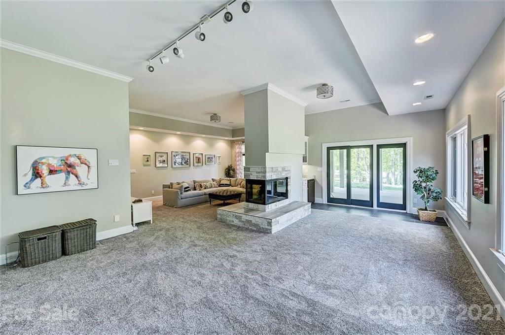 18731 River Falls Drive Davidson, NC 28036 - Photo 35 of 45 a living room with furniture large window and flat screen tv