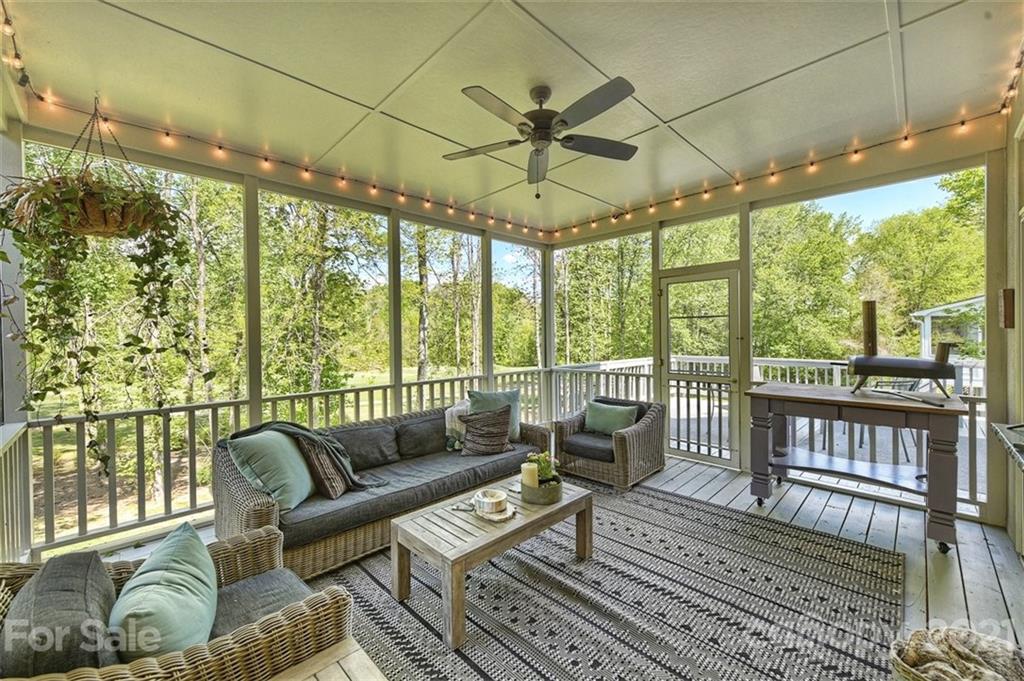 18731 River Falls Drive Davidson, NC 28036 - Photo 5 of 45 a living room with furniture and a floor to ceiling window