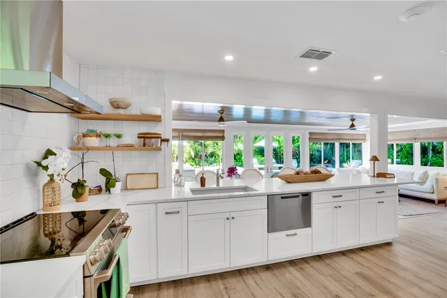 a kitchen with a stove and a white wooden cabinets