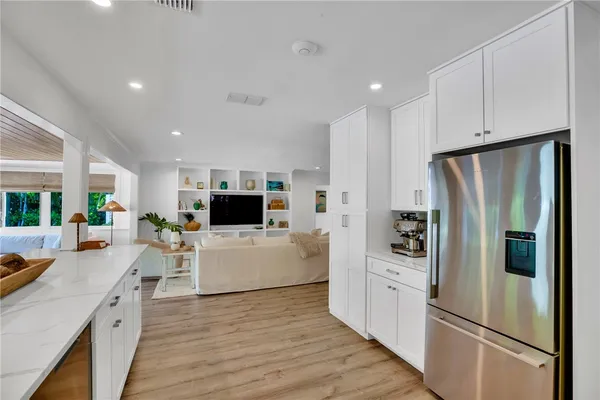 a kitchen with white cabinets and stainless steel appliances
