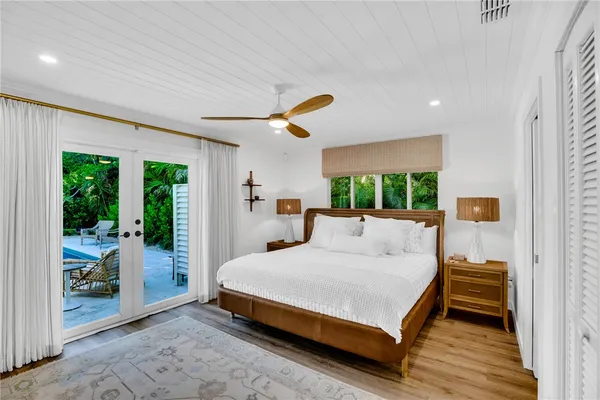 a bedroom with a large bed and a large window