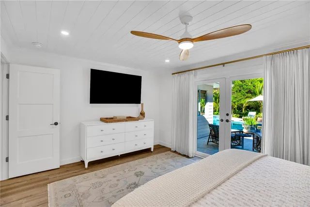 a bedroom with furniture and a flat screen tv