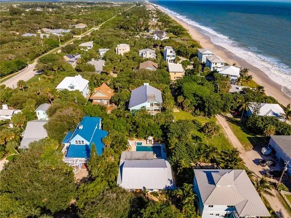 an aerial view of residential houses with outdoor space