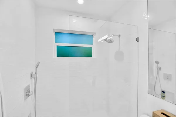 a bathroom with a mirror and a shower