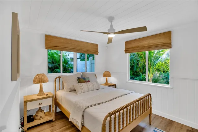 a bedroom with large window and a bed