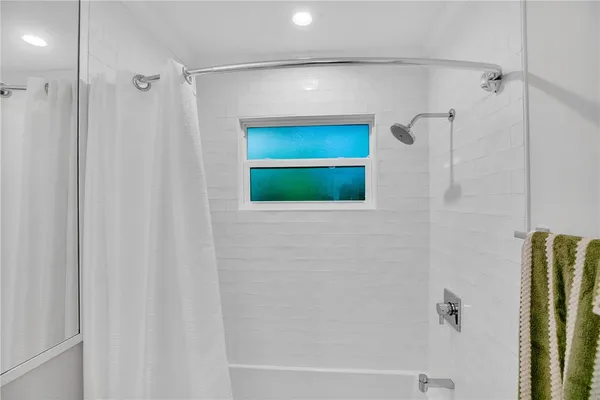 a bathroom with a shower and a mirror